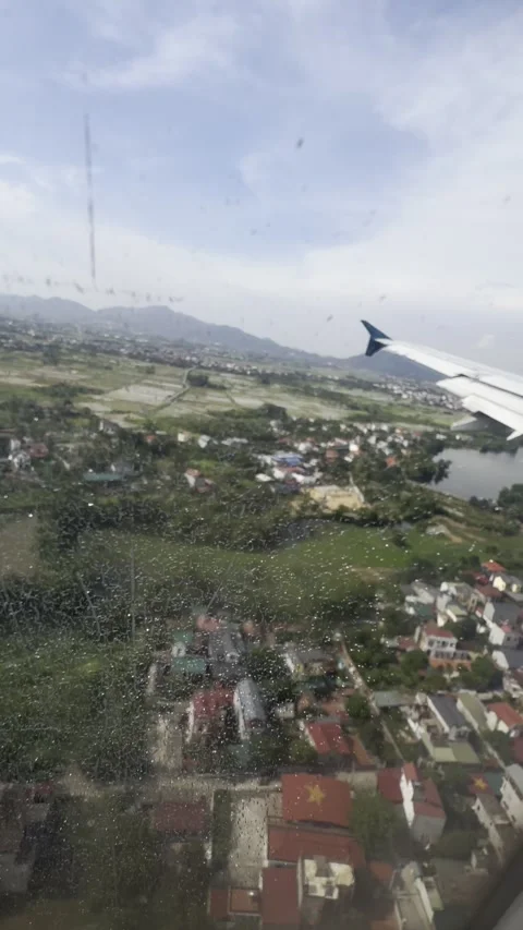 Airplane Window View – Final Approach Over Hanoi Suburbs | Vertical POV Video stock 338311175