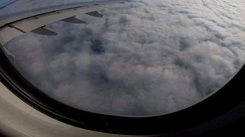 Airplane Window view Flying Above Clouds and Mountain Landscape Stock-Footage 103587216