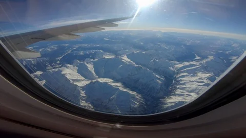 Airplane Window view Flying Above Clouds and Mountain Landscape Stock Footage 103587278