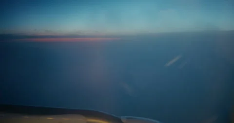 Airplane Window View Flying Through Clouds at Dusk Stock Footage 343592940