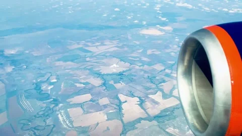 Airplane Window View with Jet Engine Above Agricultural Fields Stock Footage 329744984