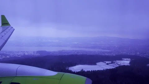 Airplane Window View Landing Over Swiss Alps and Lake Zurich in Winter Stock Footage 332054621