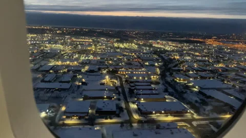 Airplane Window View of Modern City at Dusk in Winter Stock Footage 337257848