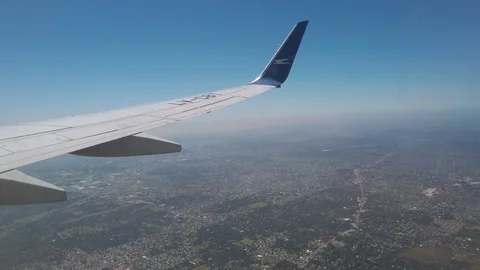 Airplane window view over city ground with Aerolineas Argentinas winglet. Stock Footage 105537103