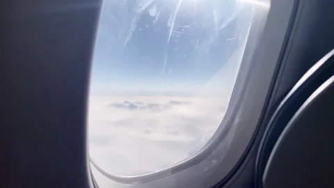 Airplane Window View Over Clouds, Travel Flight Window Seat Perspective Video stock 328835428