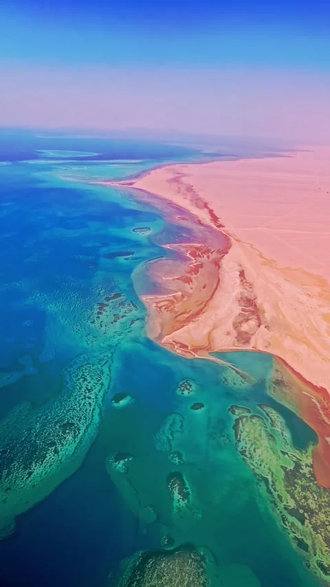 Airplane Window View Over Red Sea Showing Coral Reef Patterns and Turquoise Stock Footage 320927190