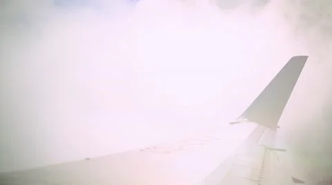 Airplane window view of plane flying through the clouds Stock Footage 48906797