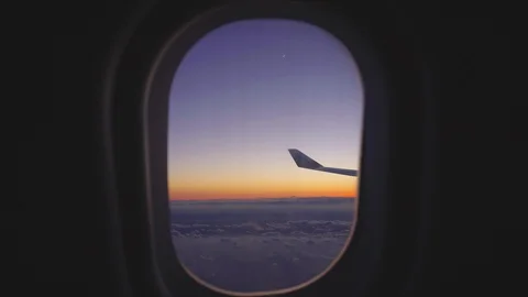 Airplane window view at sunset sunrise. passenger aircraft aviation airline Stock Footage 89732980