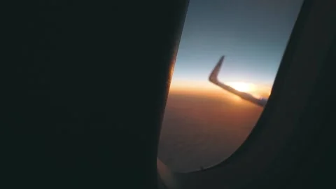 Airplane window view at sunset sunrise Stock Footage 123333335