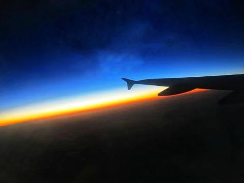 Airplane Window view at the time of sunset. Stock Photos