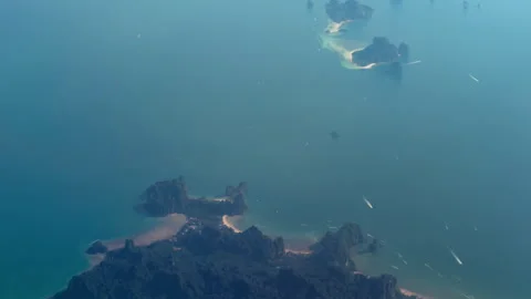 Airplane window view of vast ocean and remote islands below Video stock 312224627