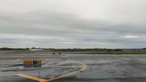 Airplane window view while passing a Delta Airlines plane at LaGuardia Airport i Stock Footage 220129371