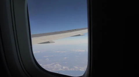 Airplane Window View of Wing Above Clouds Flying Video stock 47567262