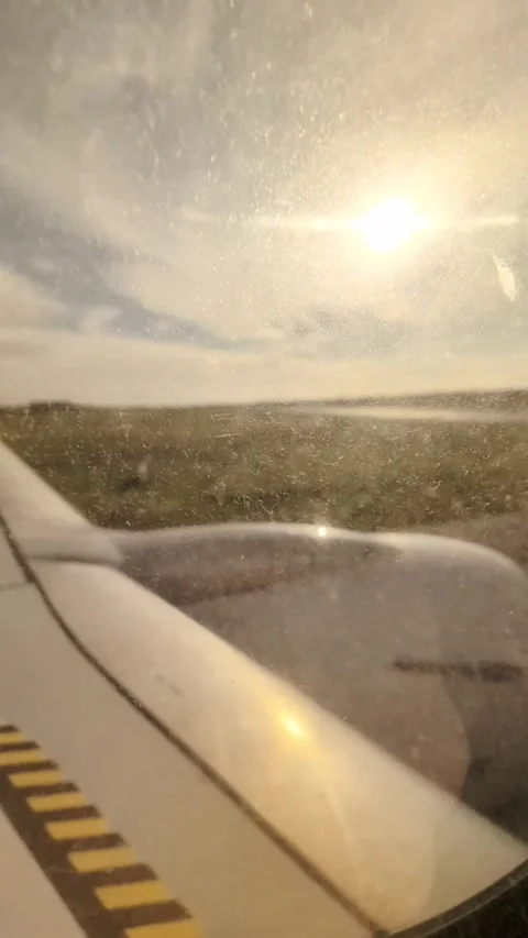Airplane window view with wing and engine taxiing on runway Video stock 335636334
