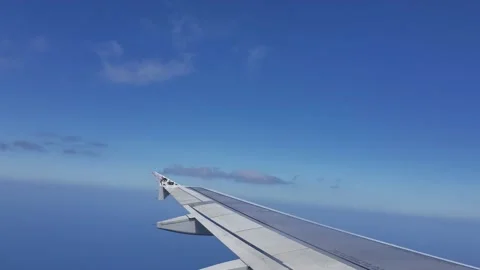 Airplane Window View, Wing Shadowed By Clouds Above Stock Footage 146551424