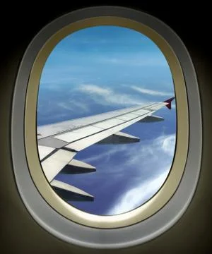 Airplane window wing view and bright cloudy blue sky Foto stock