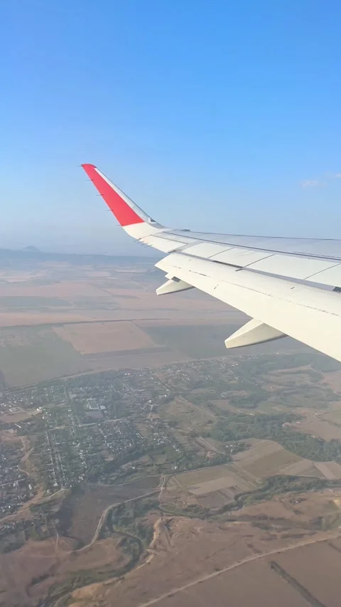 Airplane windows view above the earth on landmark down. View from an airplane Stock Footage 305600163