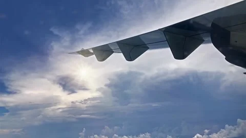 Airplane Wing Above Cloud Cover, Sunlight Through Cloudscape Video stock 310419167
