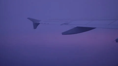 Airplane wing above the clouds at a beautiful sunset - 4K, Audio, Handheld Video stock 176287050
