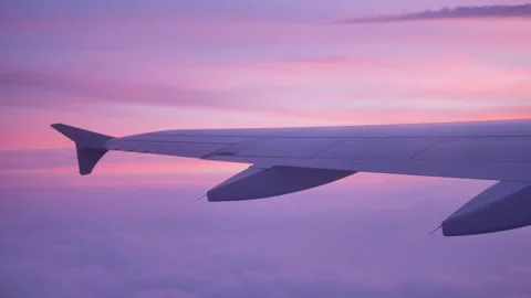 Airplane wing above the clouds at beautiful sunset - 4K Stock Footage 179876759
