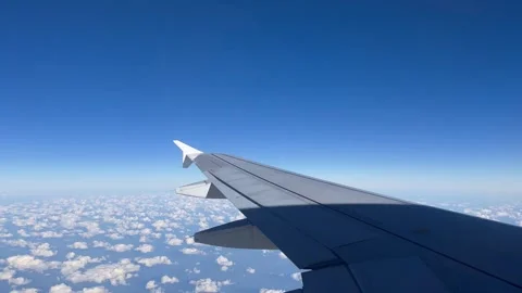Airplane wing above clouds blue sky Stock Footage 290176445