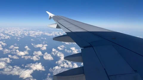 Airplane wing above clouds blue sky Stock Footage 290176455