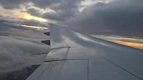 An airplane wing above the clouds at dawn on a flight to Buenos Aires. The plane Stock Footage 335174700