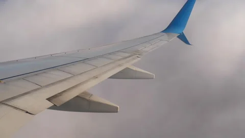 Airplane wing above clouds during commercial flight Stock Footage 334921721