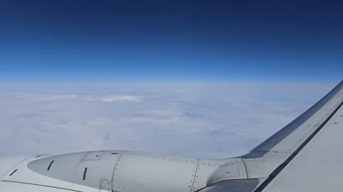 Airplane wing above clouds during cruise flight Stock Footage 345206362