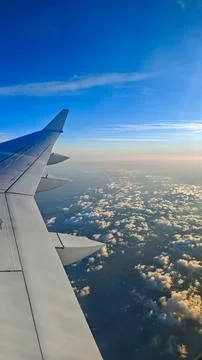Airplane wing above clouds during flight Photos