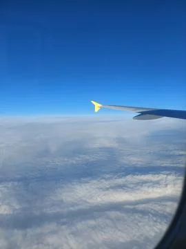 Airplane Wing Above the Clouds Stock Photos