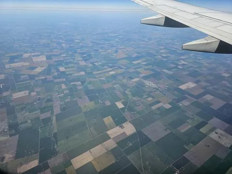 Airplane Wing Above Patchwork Farmland on Flight from Buenos Aires to Cordoba Stock Photos