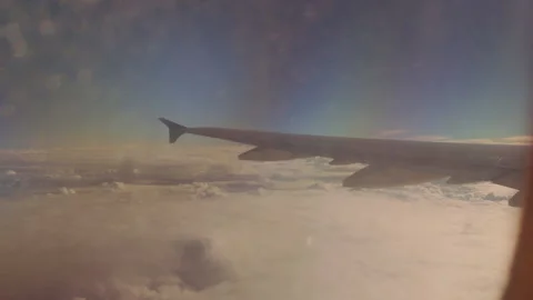 Airplane Wing above Thick Cloud Layer under Soft Sunset Glow with Wide Angle Vie Video stock 323638333