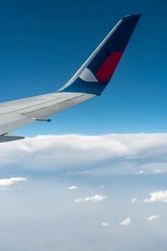 Airplane Wing and Clouds: View from Jet Window Stock Photos