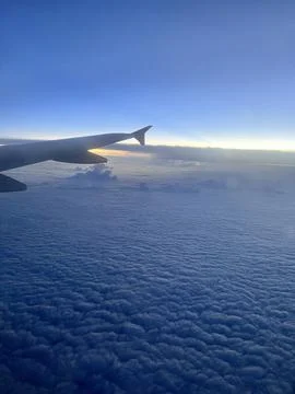 Airplane wing and clouds viewed from inside the aircraft Stock-Fotos