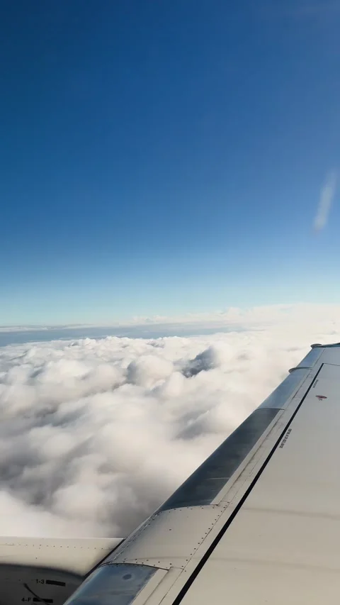 Airplane Wing and Cloudscape View from Window During Daytime Flight Over USA Stock Footage 345854286
