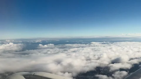 Airplane Wing and Cloudscape View from Passenger Window on Daytime USA Flight Stock Footage 345868503