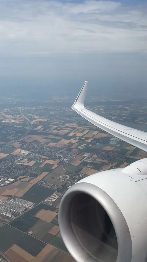 Airplane Wing and Engine View Flying Above Fields and Villages Under Clouds Stock Footage 320905877