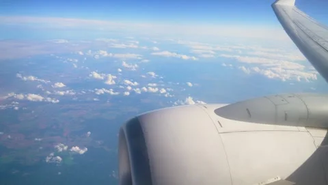 Airplane Wing and Engine View Over Landscape With Clouds During Daylight Flight Stock Footage 323598194