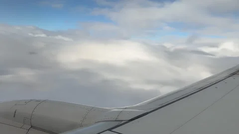 Airplane Wing and Illuminated Clouds Stock Footage 220552344