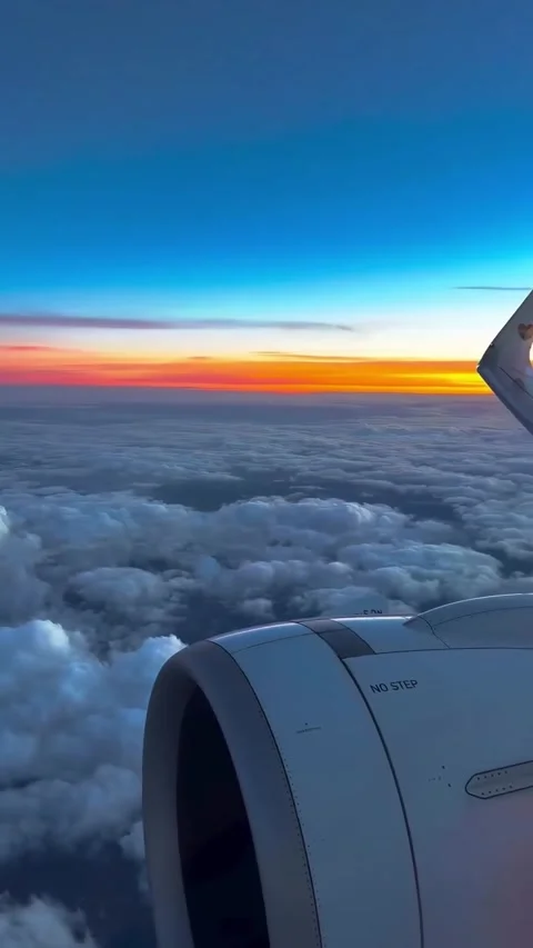 Airplane Wing and Sunset Above Clouds Stock Footage 341317171