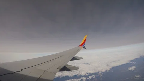 Airplane Wing Below Cloud Layer from Window, 4k Stock Footage 88641183