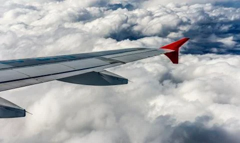 Airplane wing between the clouds Stock Photos