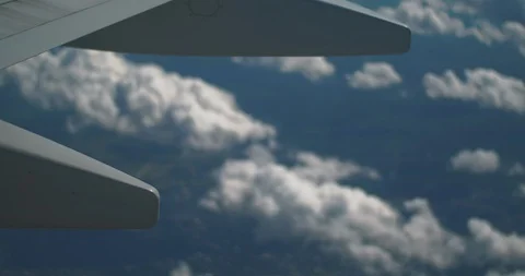 Airplane wing closeup with clouds behind. Stock Footage 129855062