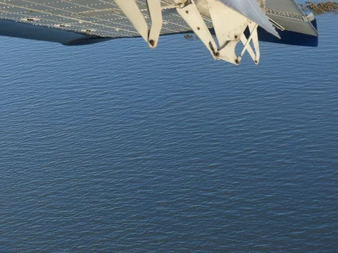 Airplane wing closeup flight over water backgroound Stock Footage 81847180