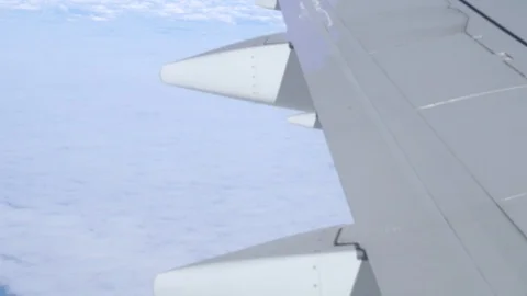 Airplane wing on a cloud background. Bird's-eye Stockbeeldmateriaal 101384840