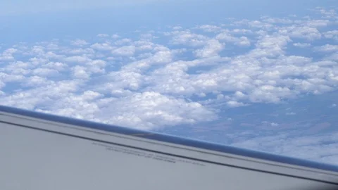 Airplane wing on a cloud background. Bird's-eye Stockbeeldmateriaal 101385070
