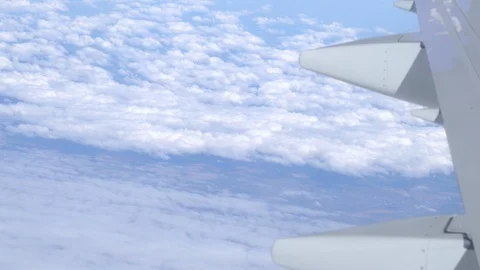Airplane wing on a cloud background. Bird's-eye Stockbeeldmateriaal 101385522