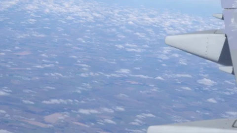 Airplane wing on a cloud background. Bird's-eye Stockbeeldmateriaal 101386925