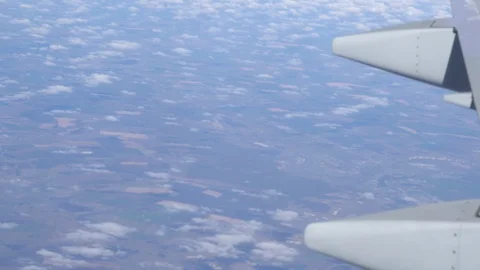 Airplane wing on a cloud background. Bird's-eye Stockbeeldmateriaal 101387214